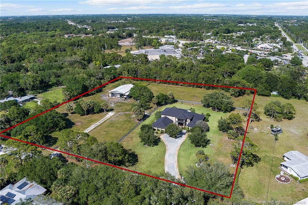 6655 Southwest Gaines Avenue Stuart, FL 34997 - Photo 41 of 48 an aerial view of residential houses with outdoor space and trees