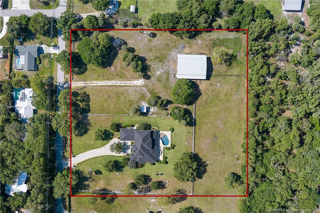 6655 Southwest Gaines Avenue Stuart, FL 34997 - Photo 46 of 48 an aerial view of a house with a yard and garden