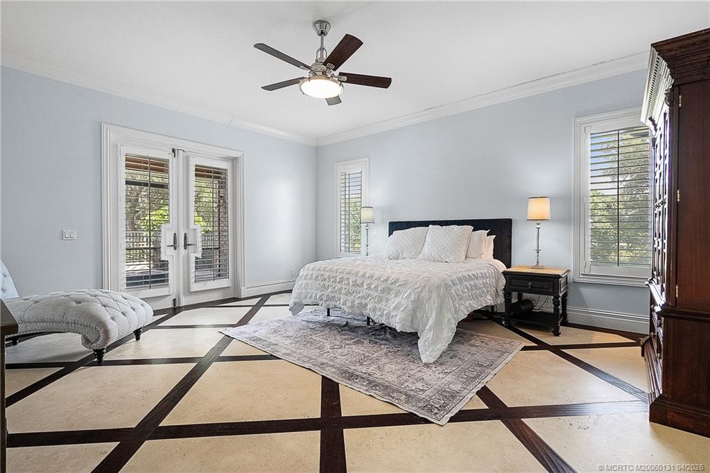 6655 Southwest Gaines Avenue Stuart, FL 34997 - Photo 5 of 48 a bedroom with a bed a couch and a window