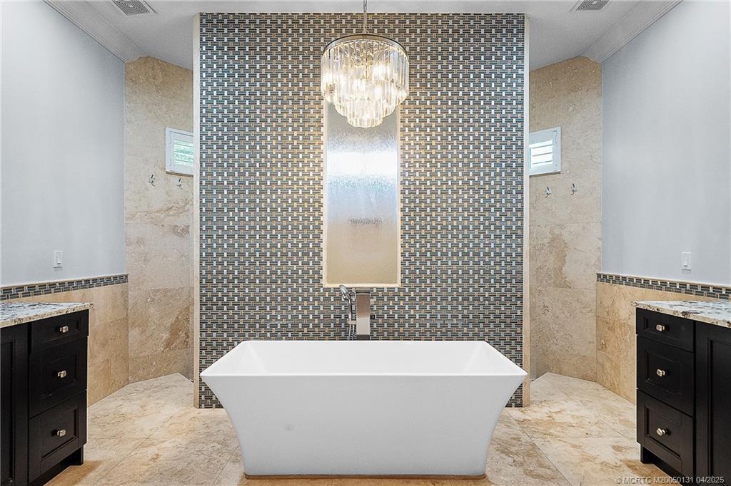 6655 Southwest Gaines Avenue Stuart, FL 34997 - Photo 6 of 48 a bathroom with a bathtub and shower