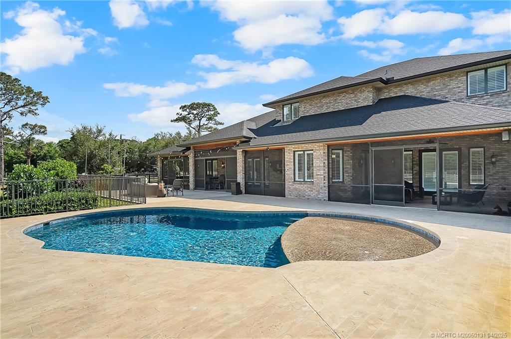 6655 Southwest Gaines Avenue Stuart, FL 34997 - Photo 8 of 48 a view of a house with swimming pool and a yard