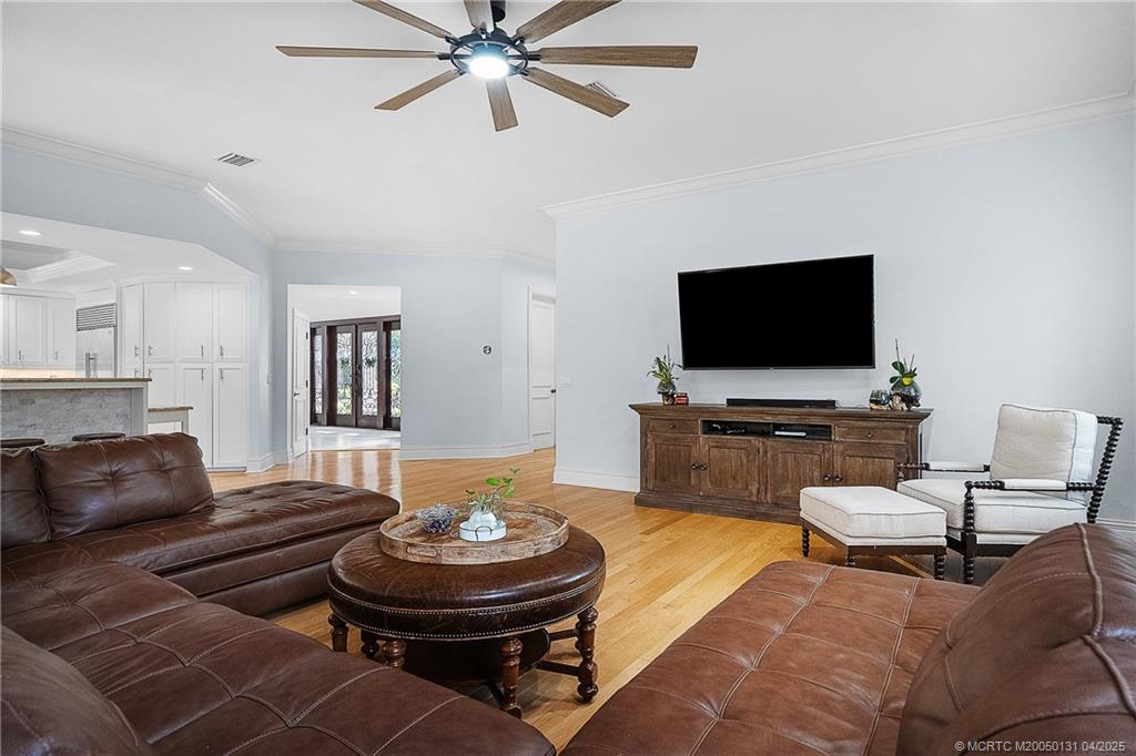 6655 Southwest Gaines Avenue Stuart, FL 34997 - Photo 9 of 48 a living room with furniture and a flat screen tv