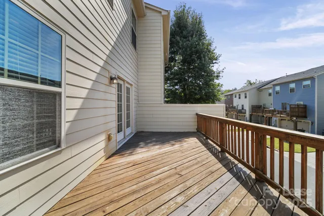 a view of balcony with wooden floor and fence and stairs