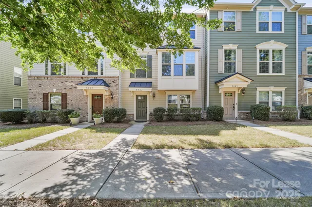 a front view of a residential apartment building with a yard