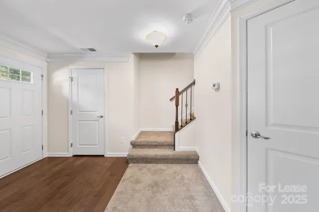 a view of entryway and hall with wooden floor
