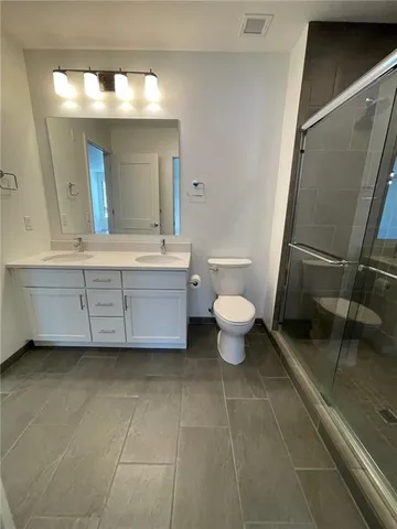 a bathroom with a toilet a sink and mirror