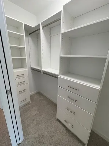 a view of a hallway with wooden walls