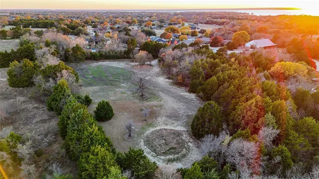 an aerial view of a houses with a yard