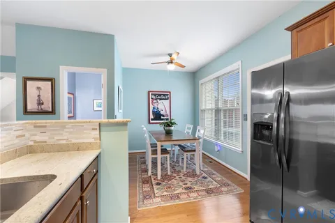 a living room with furniture a ceiling fan and a rug