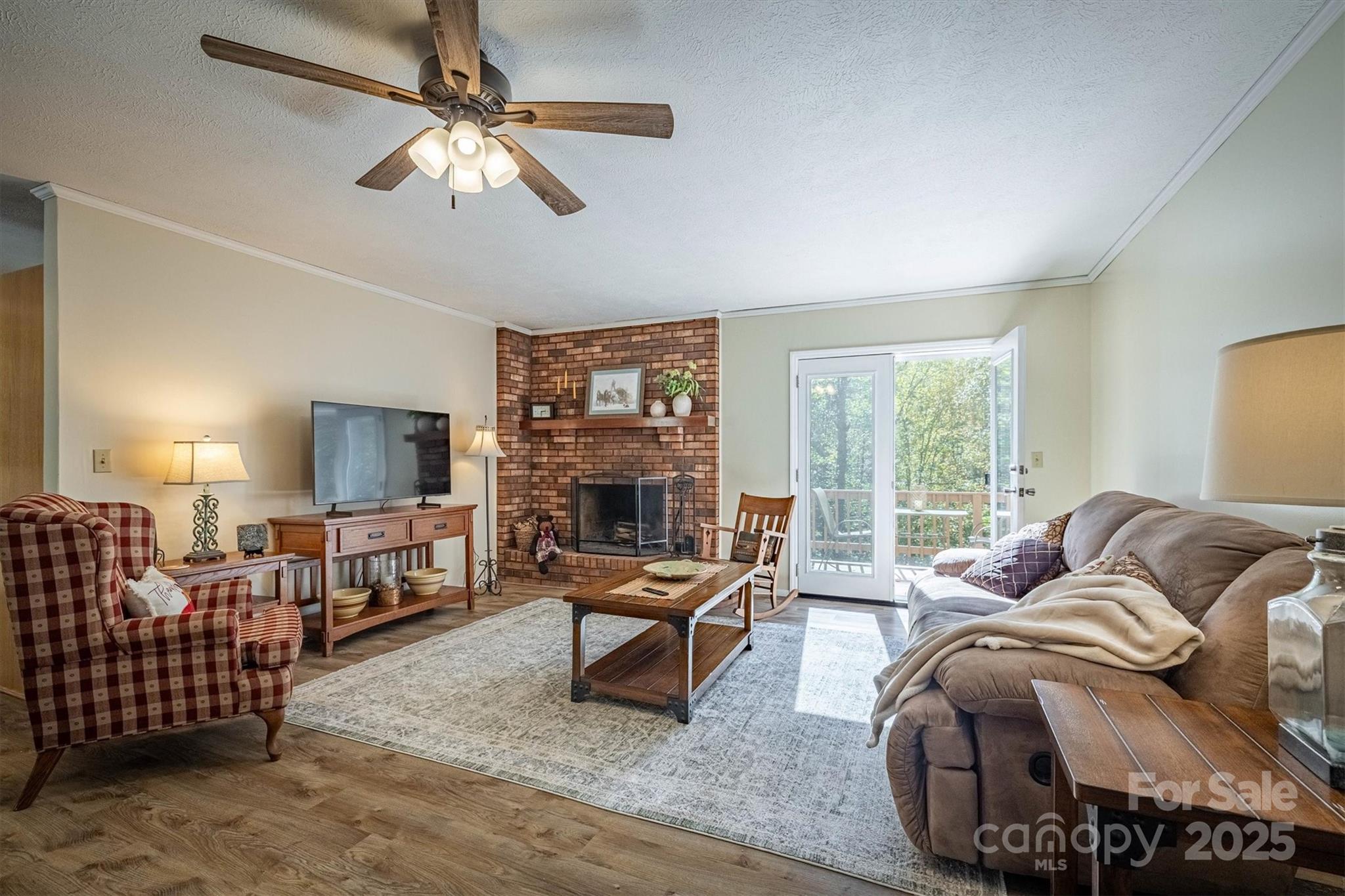 a living room with furniture ceiling fan and a window