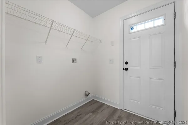 an empty room with windows and ceiling fan