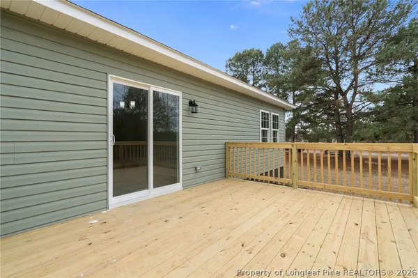 a view of deck with a large trees