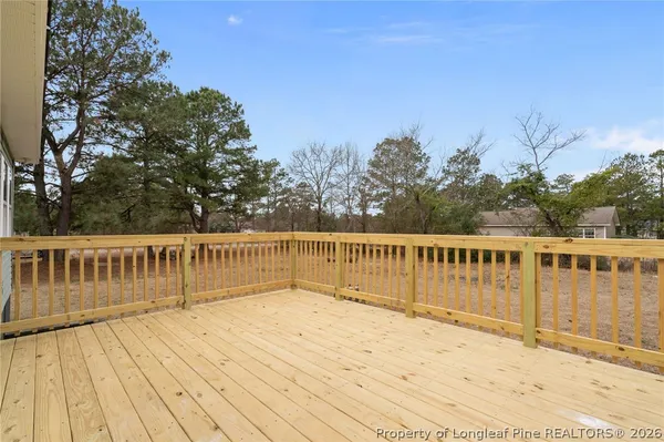 a view of balcony with wooden floor and fence