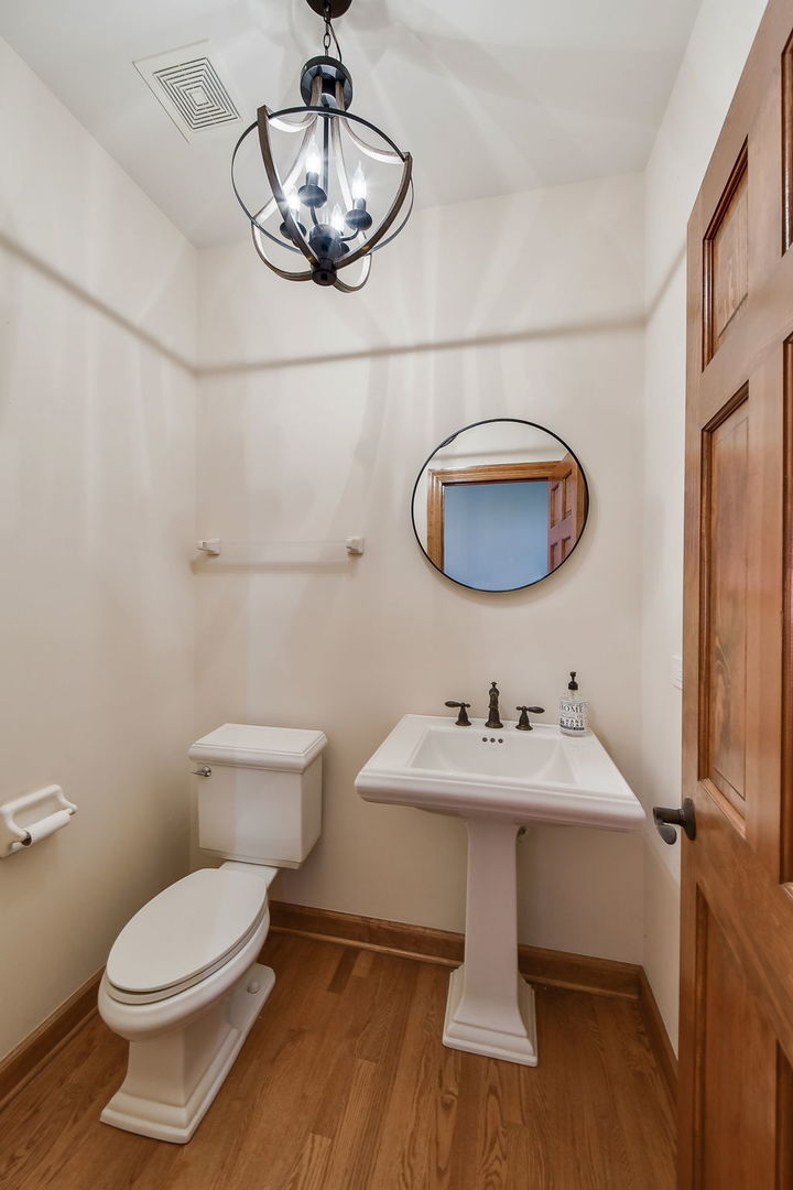 2003 Mackenzie Place Wheaton, IL 60187 - Photo 13 of 25 a bathroom with a toilet a sink and mirror