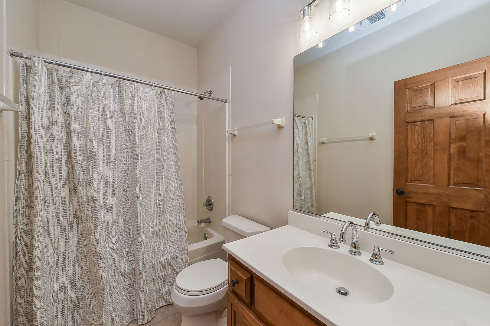2003 Mackenzie Place Wheaton, IL 60187 - Photo 19 of 25 a bathroom with a sink a toilet and shower curtain