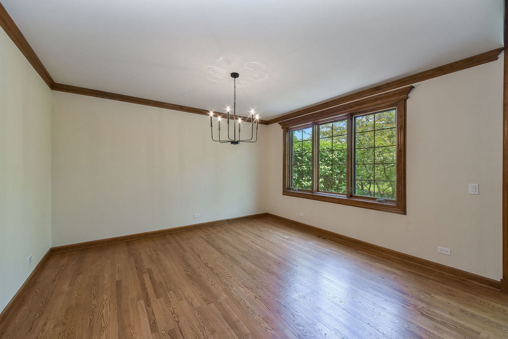 2003 Mackenzie Place Wheaton, IL 60187 - Photo 6 of 25 a view of an empty room with wooden floor and a window