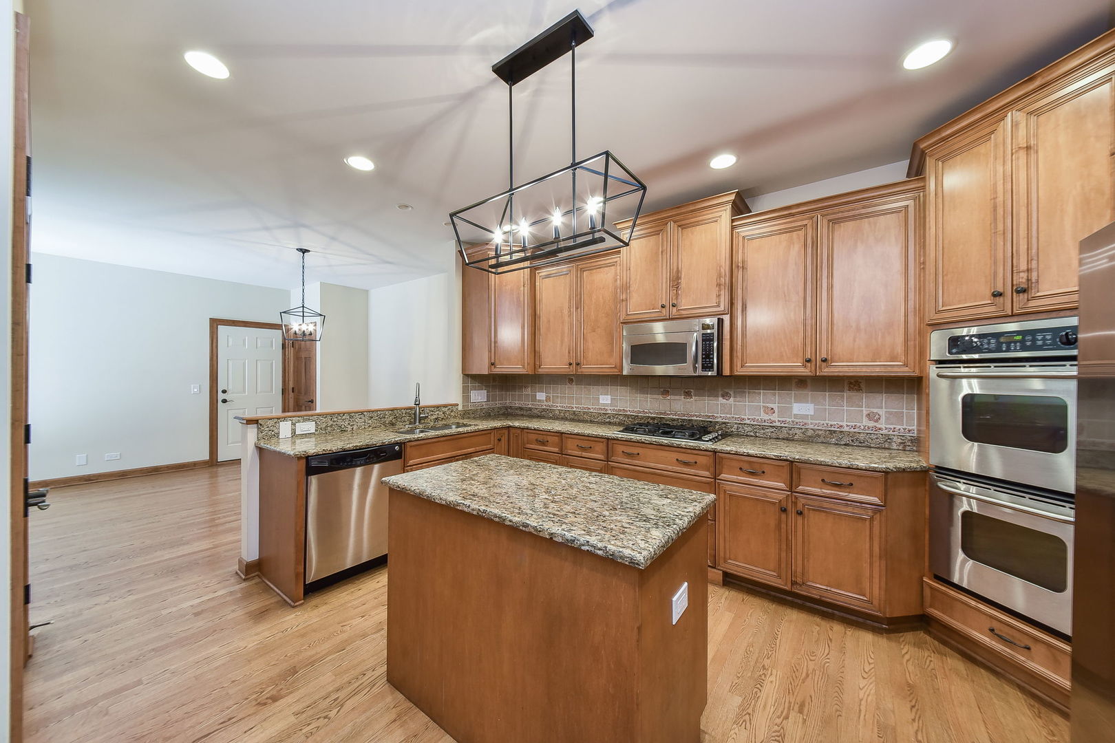 2003 Mackenzie Place Wheaton, IL 60187 - Photo 9 of 25 a kitchen with stainless steel appliances granite countertop a sink stove and refrigerator