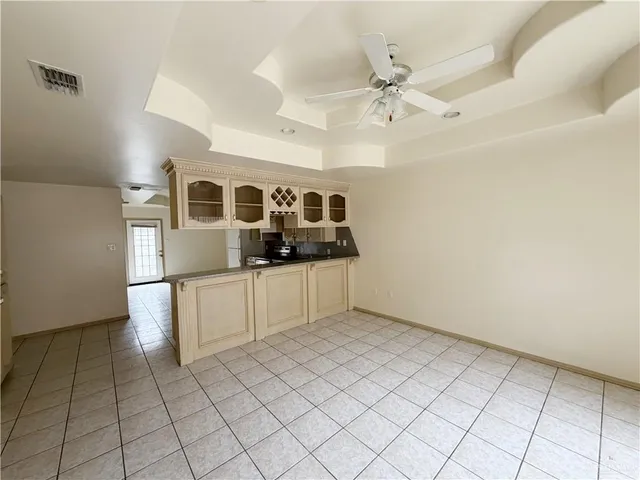 a view of an empty room with a kitchen