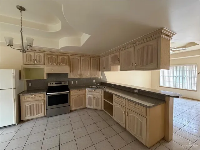 a kitchen with stainless steel appliances granite countertop a stove and a sink