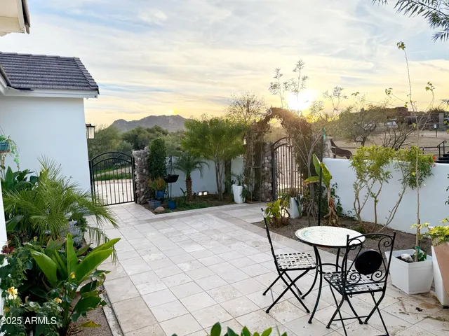 a view of a chairs and table in the patio