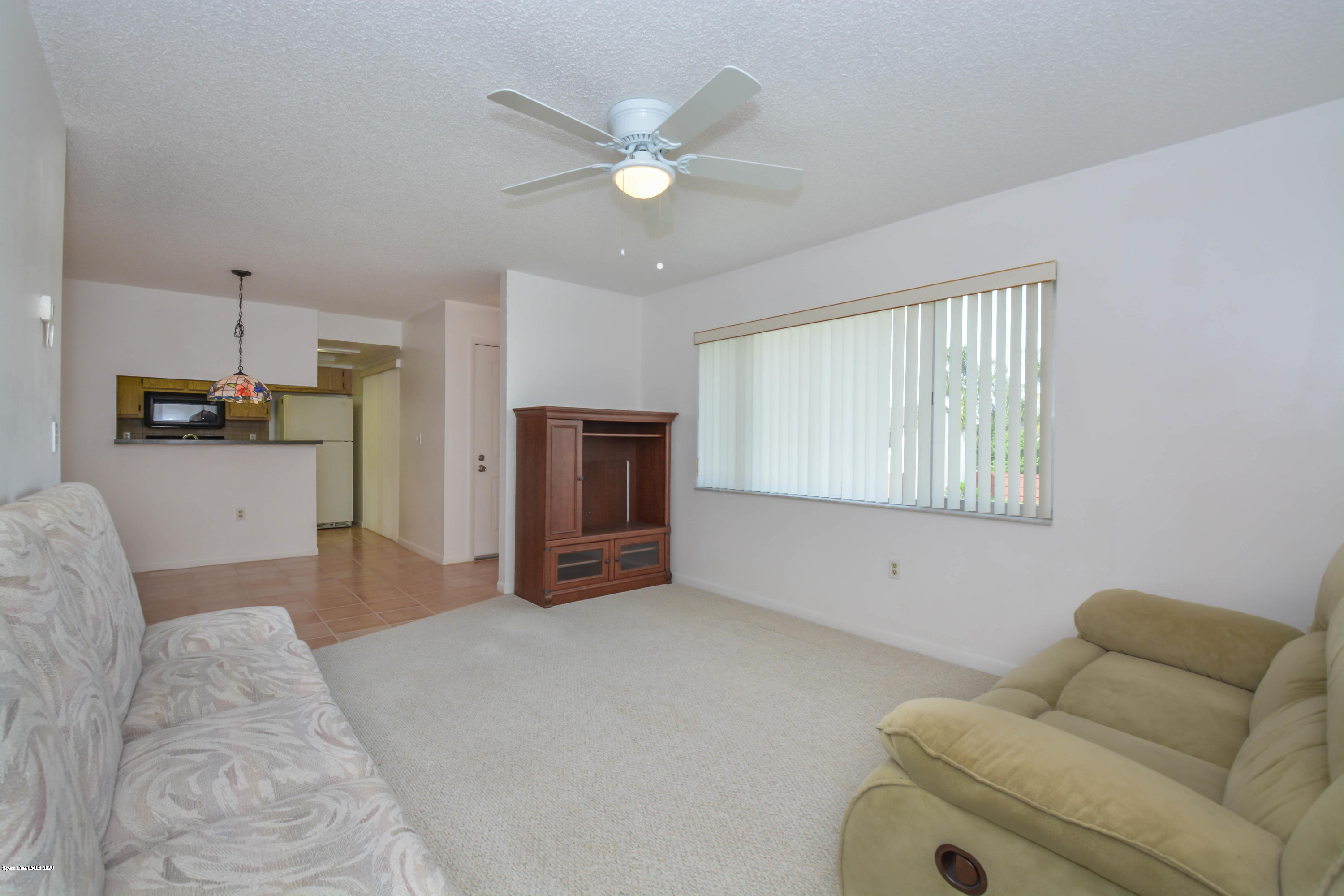 610 North Wickham Road, Unit 74 Melbourne, FL 32935 - Photo 15 of 46 a living room with furniture and kitchen view