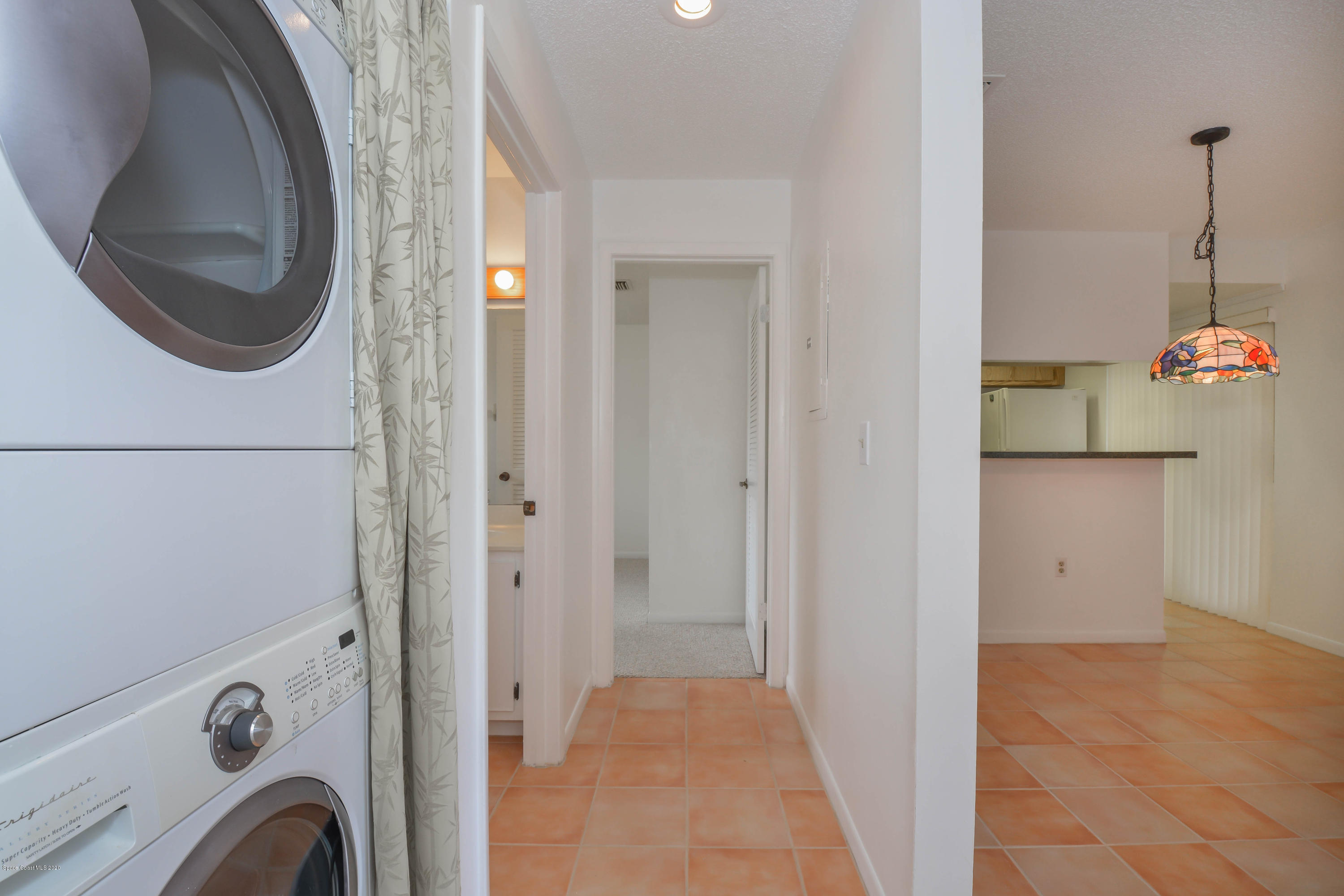 610 North Wickham Road, Unit 74 Melbourne, FL 32935 - Photo 16 of 46 a view of a hallway with washer and dryer