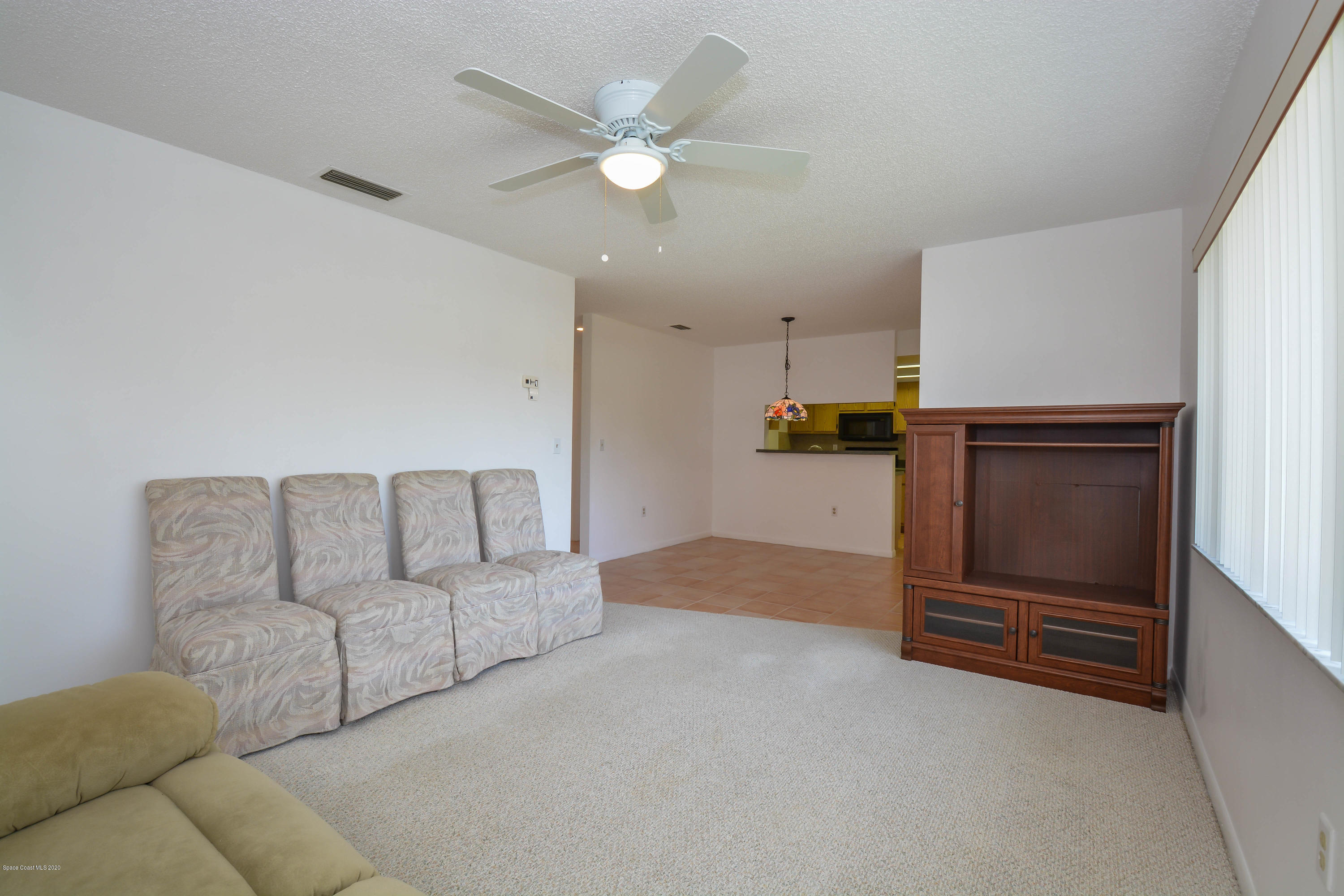 610 North Wickham Road, Unit 74 Melbourne, FL 32935 - Photo 33 of 46 a living room with furniture and a ceiling fan