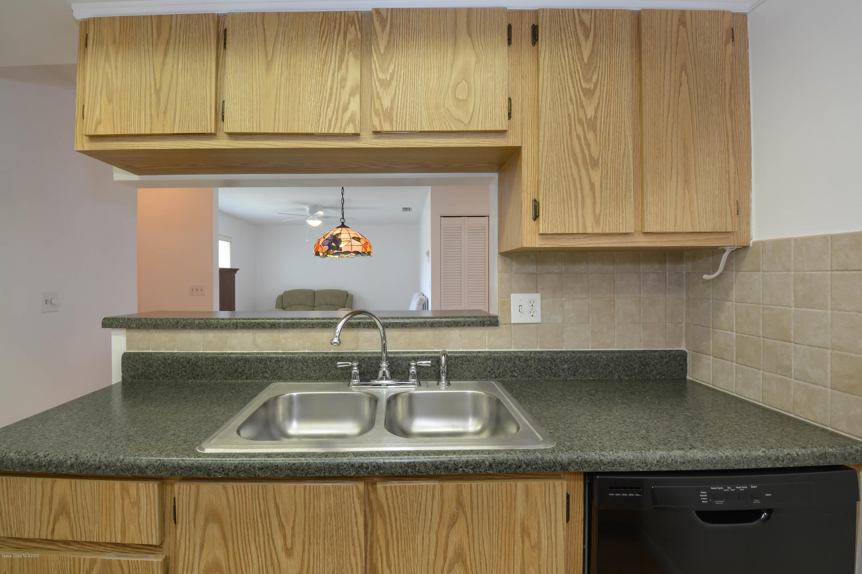 610 North Wickham Road, Unit 74 Melbourne, FL 32935 - Photo 36 of 46 a kitchen with a sink and cabinets