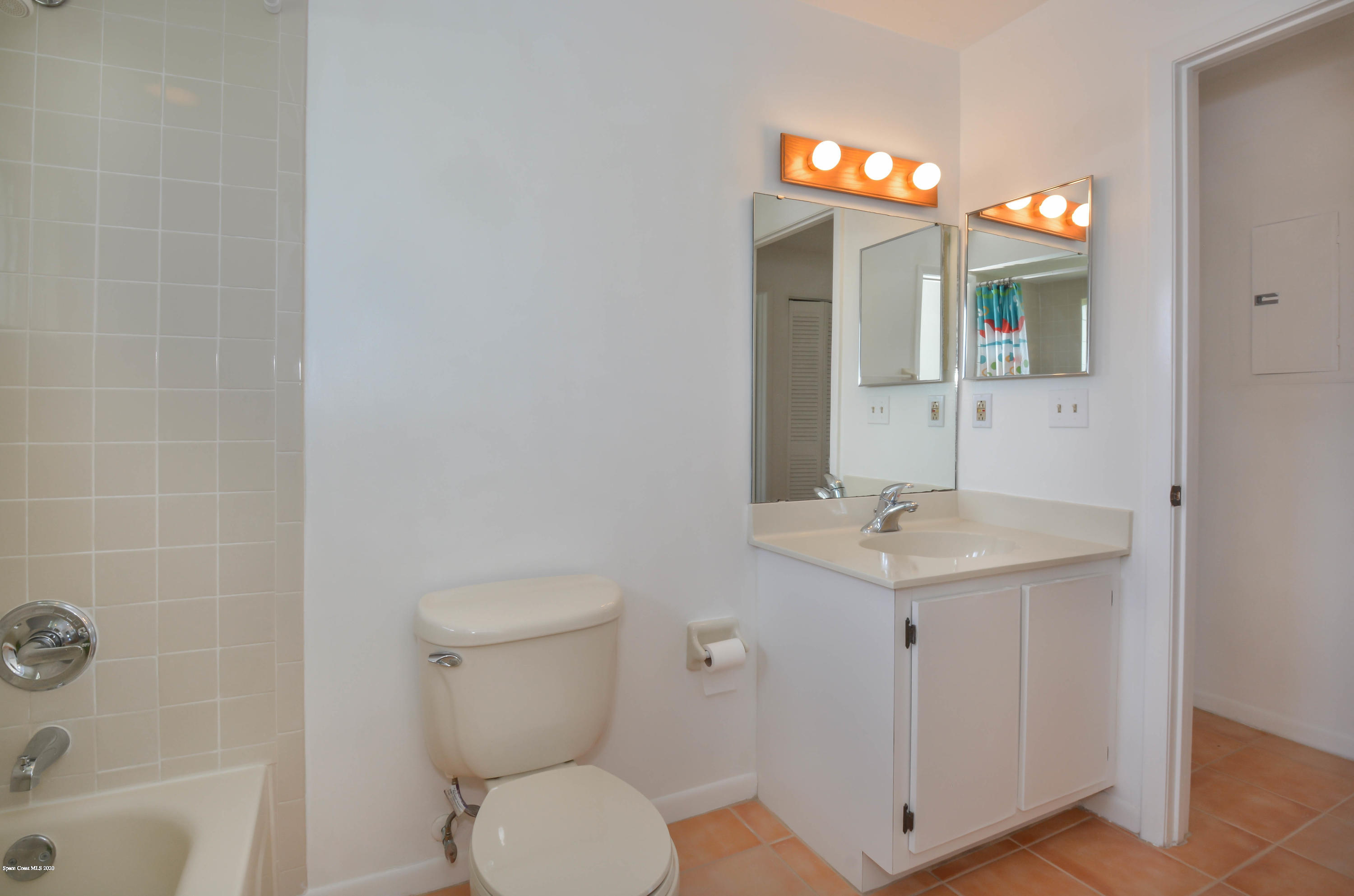 610 North Wickham Road, Unit 74 Melbourne, FL 32935 - Photo 42 of 46 a bathroom with a sink a toilet and mirror