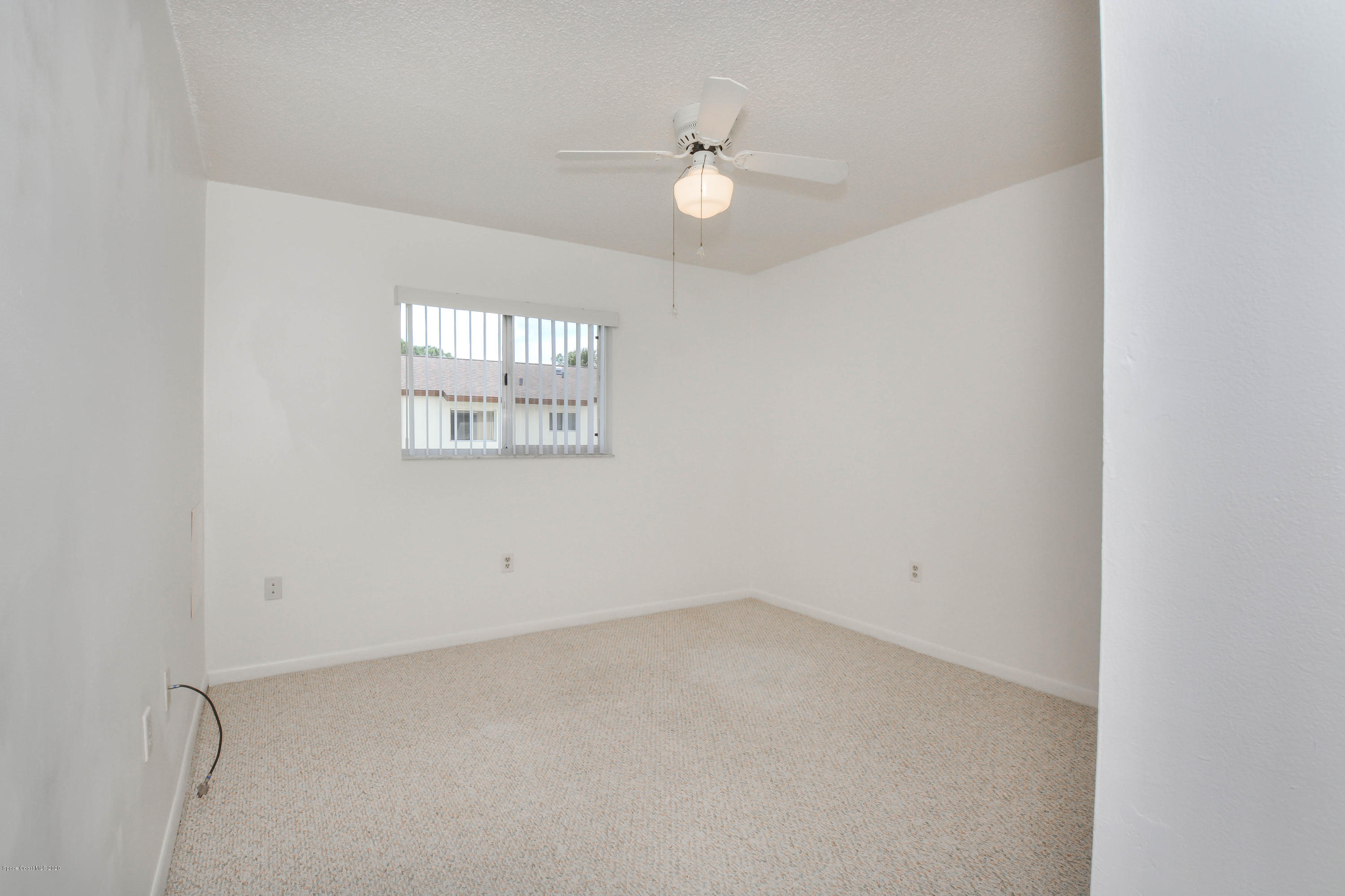 610 North Wickham Road, Unit 74 Melbourne, FL 32935 - Photo 43 of 46 an empty room with a window