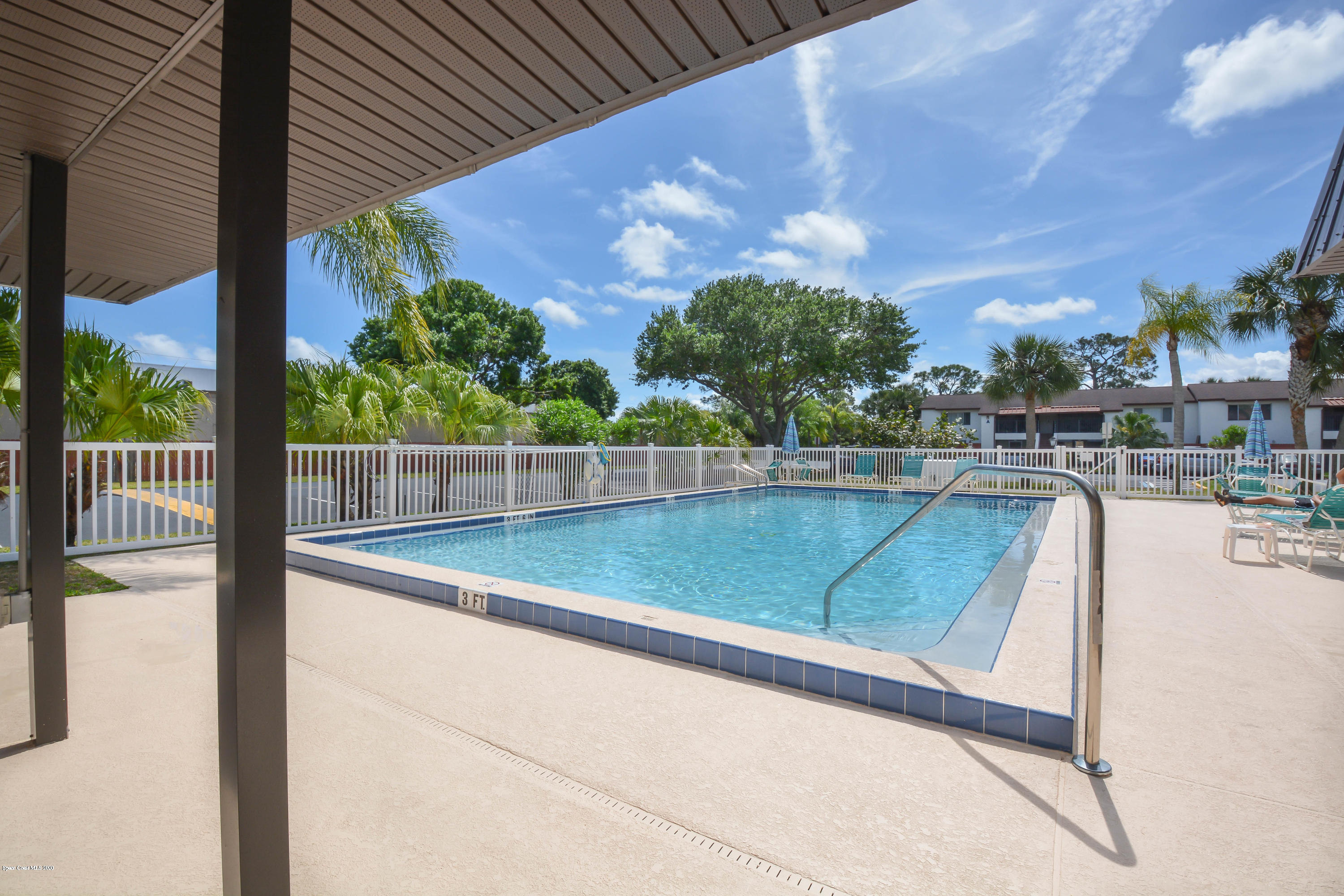 610 North Wickham Road, Unit 74 Melbourne, FL 32935 - Photo 45 of 46 a view of a swimming pool with a patio