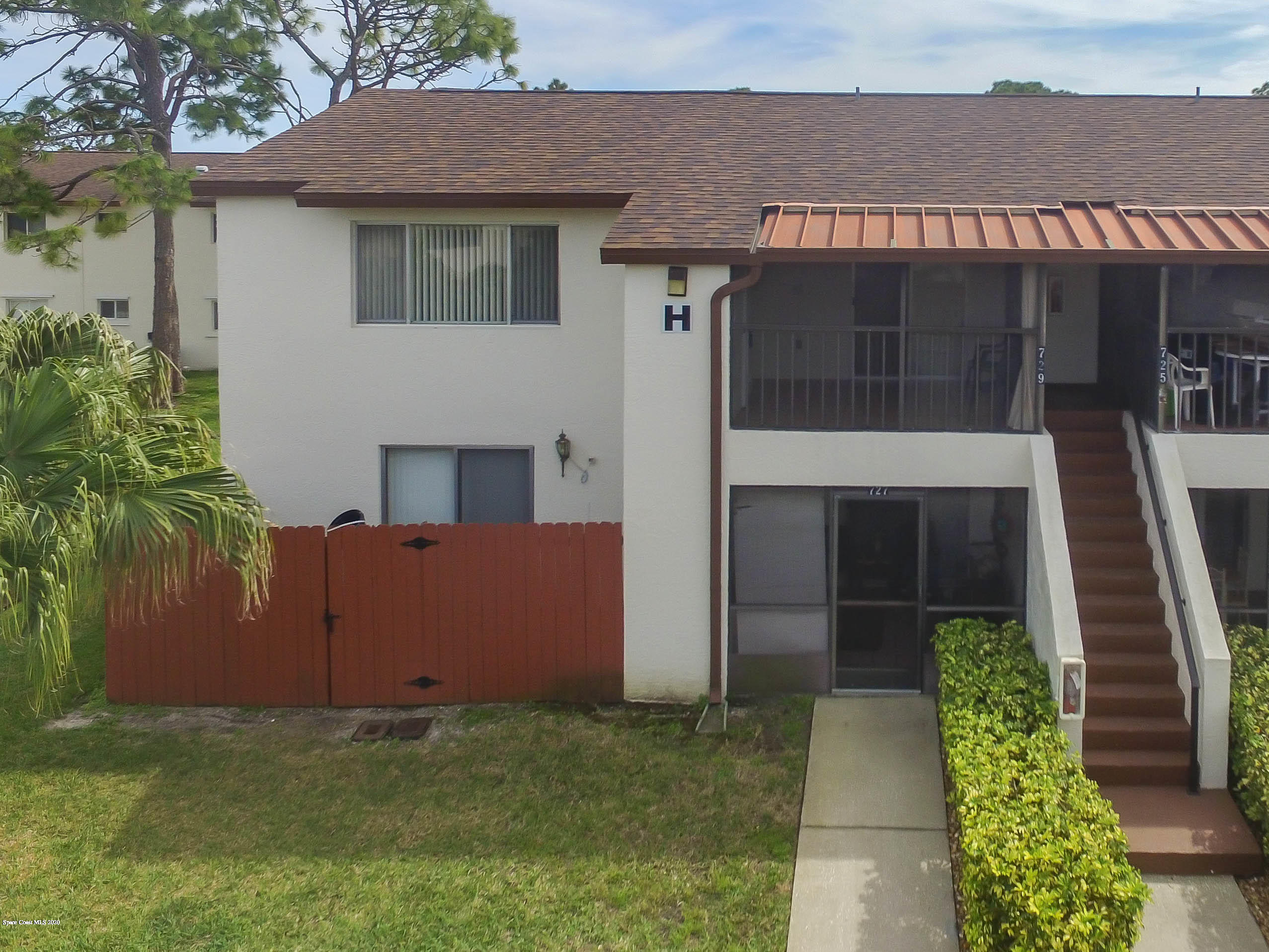 610 North Wickham Road, Unit 74 Melbourne, FL 32935 - Photo 46 of 46 a view of a house with a yard