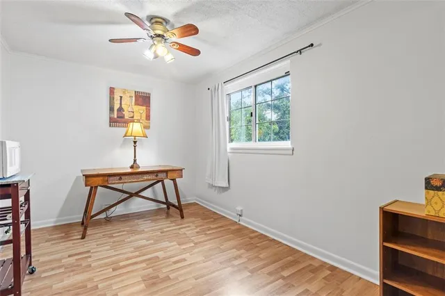 a work room with furniture and a wooden floor