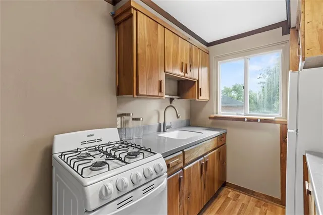 a kitchen with a stove a sink and a microwave