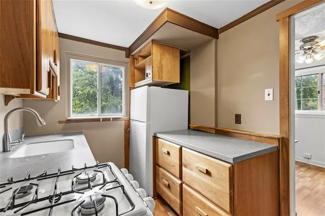 a view of a kitchen with a sink and a window
