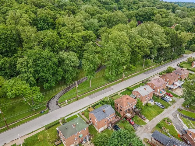 an aerial view of a houses with yard