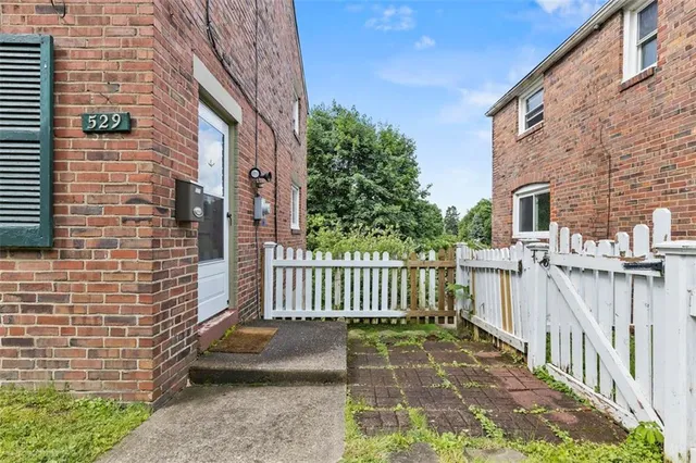 a view of a brick wall in front of a building