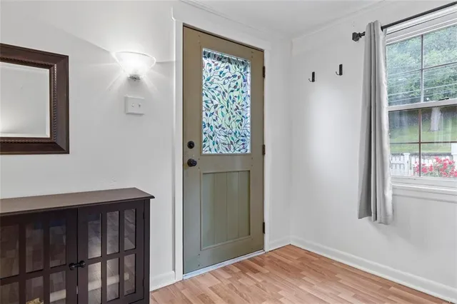 a view of an entryway with wooden floor