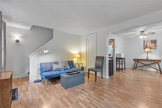 a living room with furniture and a wooden floor