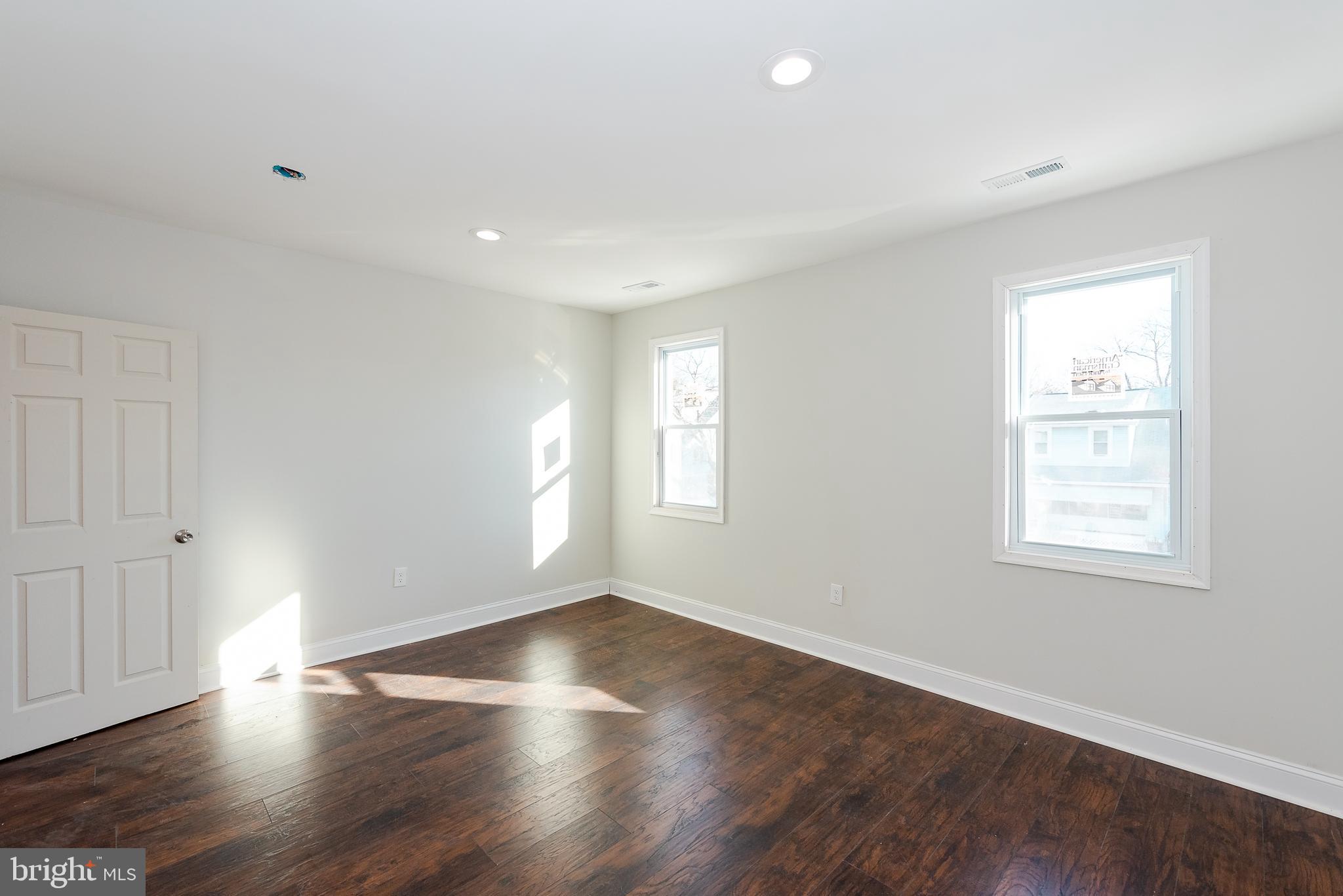 22 Ridge Road Baltimore, MD 21228 - Photo 22 of 29 an empty room with wooden floor and windows