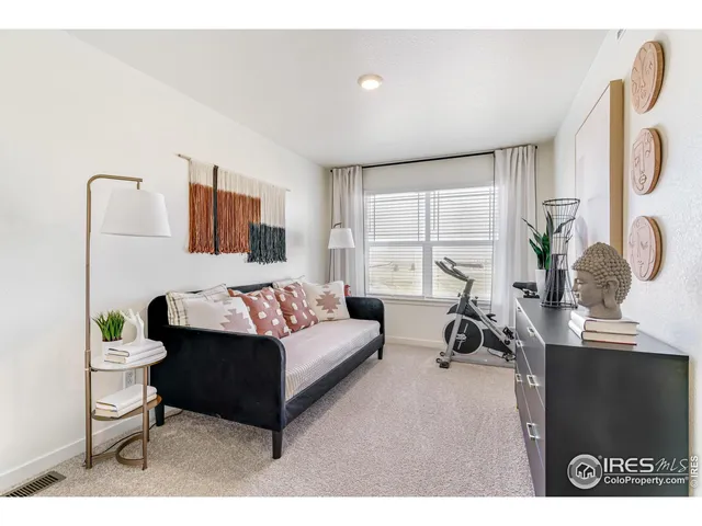 a living room with furniture a flat screen tv and a large window