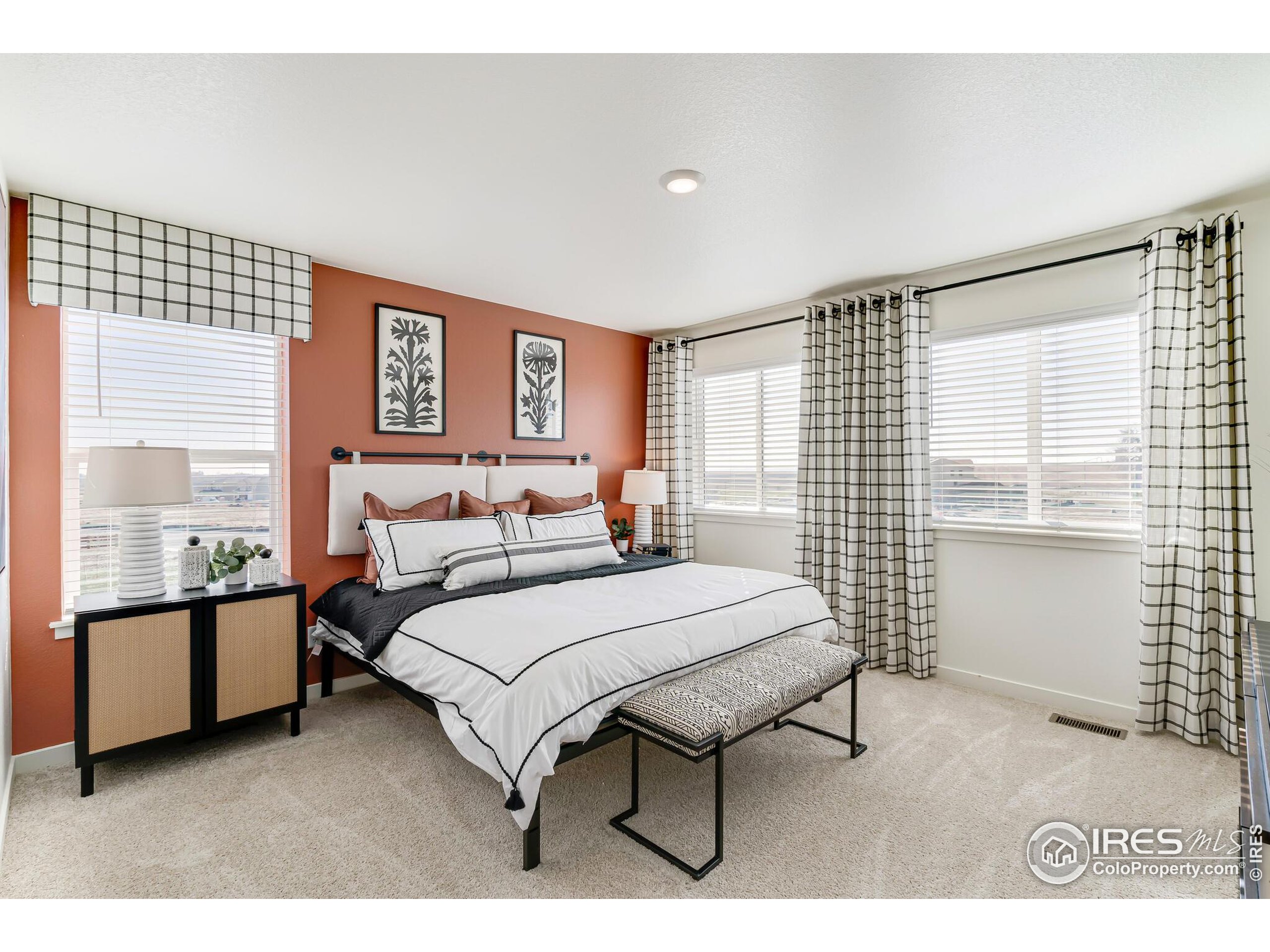 920 Logan Peak Way Berthoud, CO 80513 - Photo 19 of 35 a spacious bedroom with a bed and a window