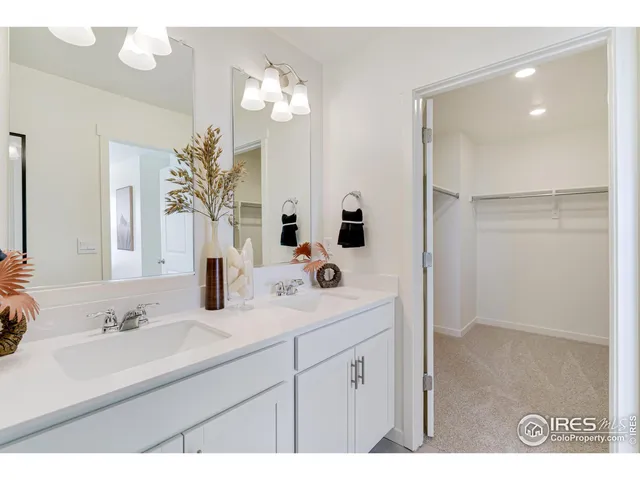 a bathroom with a sink double vanity and a mirror
