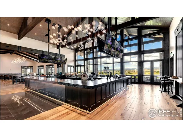 a open kitchen with a sink and a large window