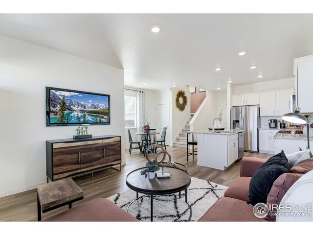 a living room with furniture a a piano and a flat screen tv