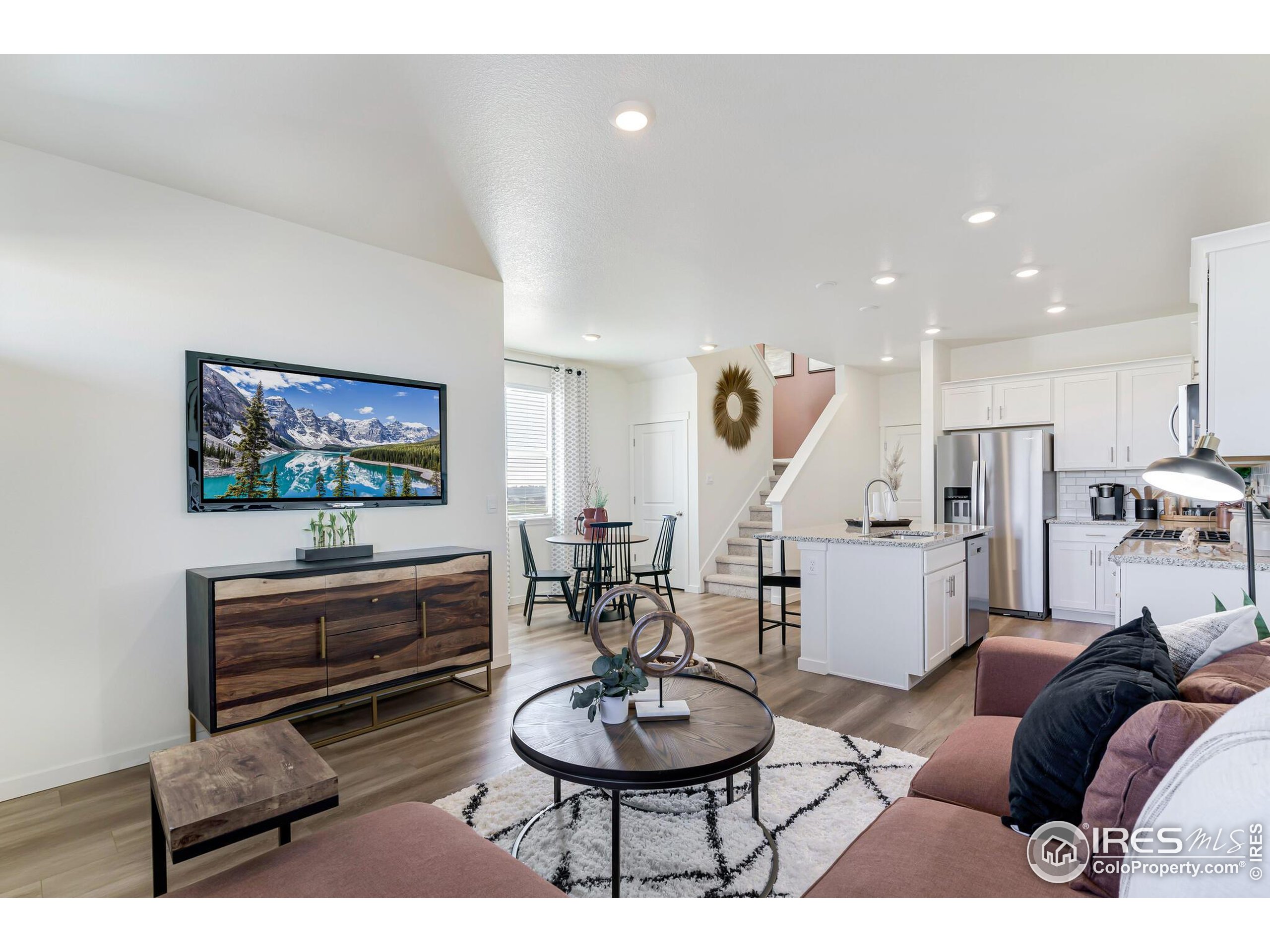 920 Logan Peak Way Berthoud, CO 80513 - Photo 4 of 35 a living room with furniture a a piano and a flat screen tv