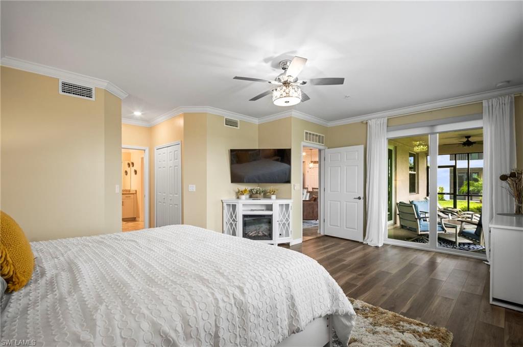 15919 Grassland Lane, Unit 4211 Babcock Ranch, FL 33982 - Photo 23 of 35 a bedroom with a bed and a flat screen tv