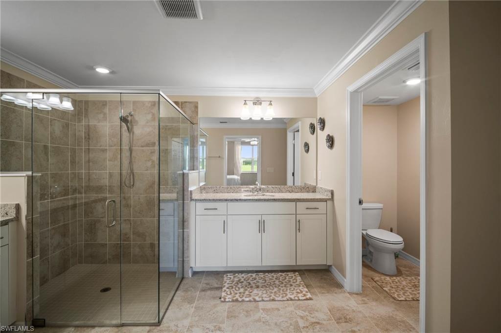 15919 Grassland Lane, Unit 4211 Babcock Ranch, FL 33982 - Photo 25 of 35 a bathroom with a granite countertop sink a toilet and shower