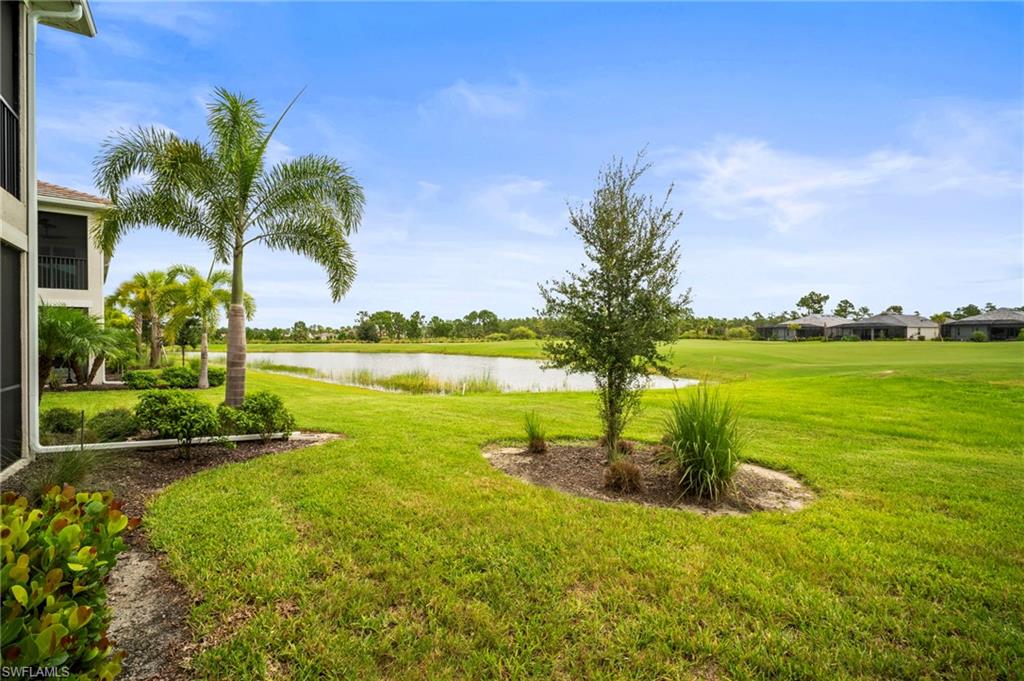 15919 Grassland Lane, Unit 4211 Babcock Ranch, FL 33982 - Photo 34 of 35 a view of a lake with a big yard