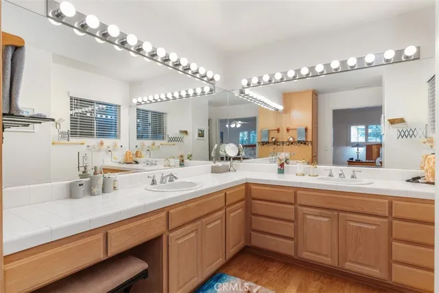 a bathroom with double vanity and a mirror
